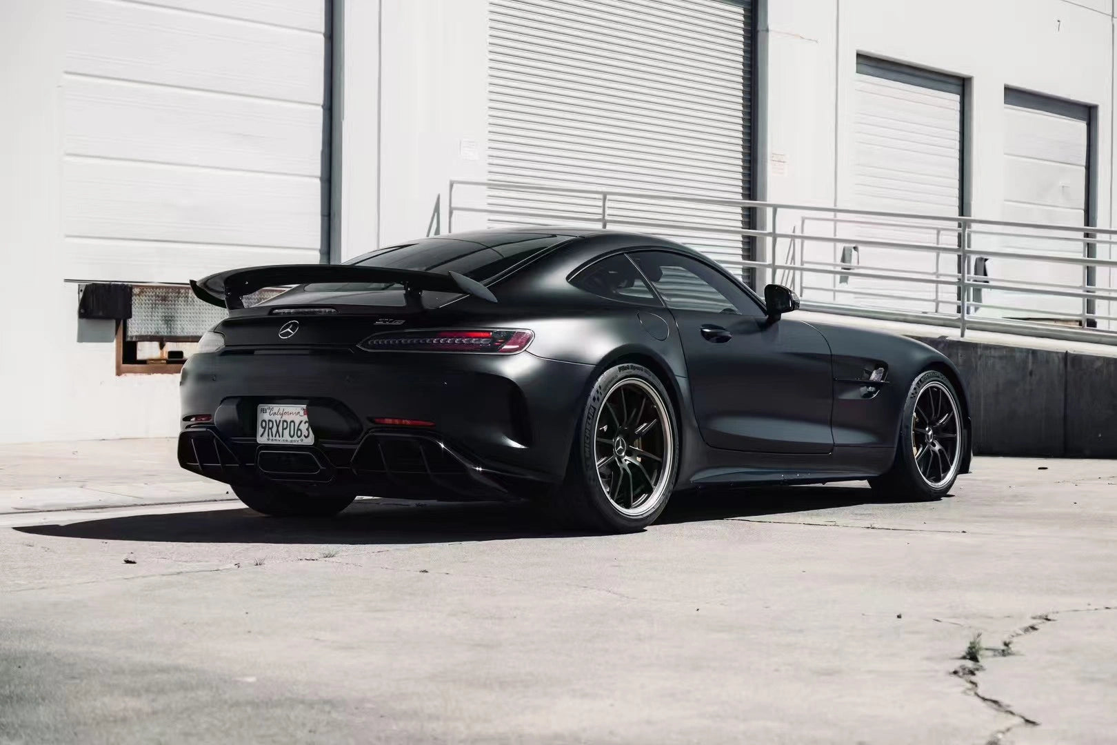 Rear-right view of Silky Noir wrapped AMG GT R - showcasing rear wing and diffuser - Kaleido