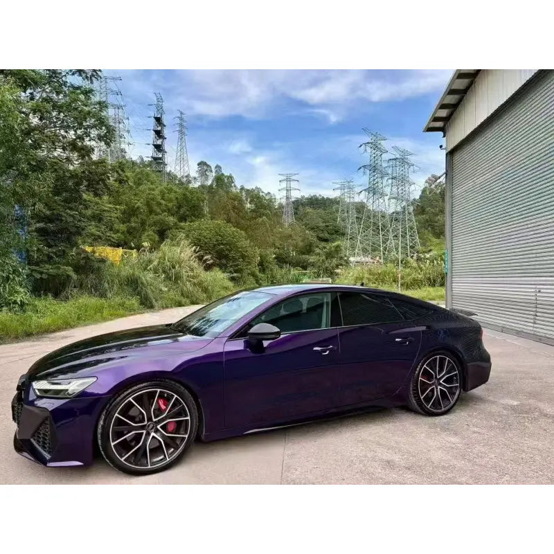 Full side profile of an Audi RS7 sportsback wrapped in Midnight Purple Metallic gloss vinyl - Showing the elegant fastback lines - Kaleido