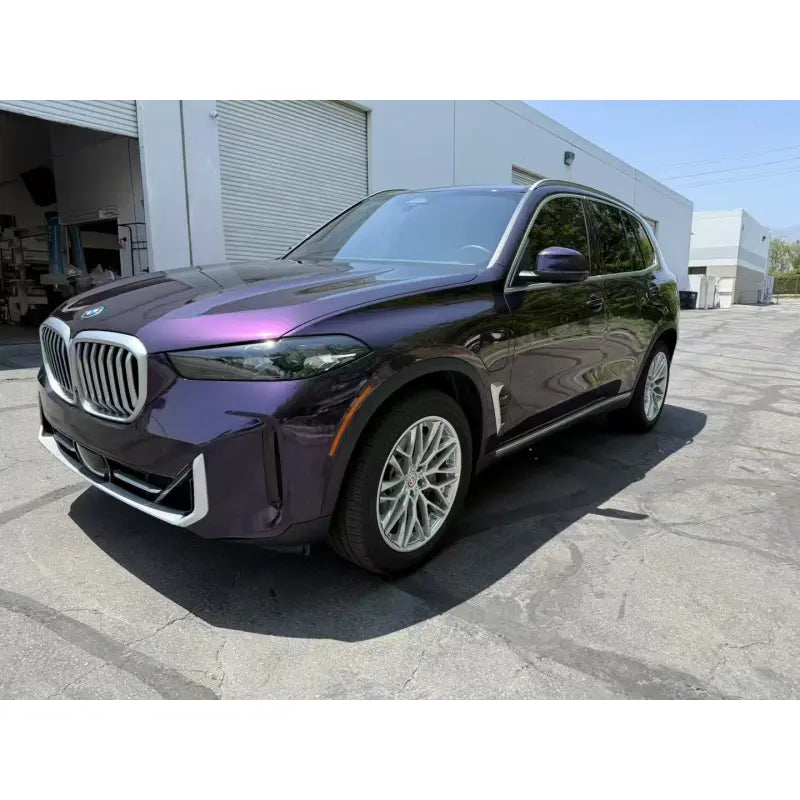 Midnight Purple Metallic vinyl wrap on the front-left side of a BMW X5 SUV - Kaleido