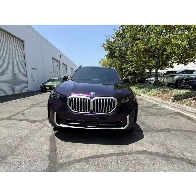 Powerful front view of the BMW X5 in Midnight Purple Metallic vinyl wrap - Kaleido