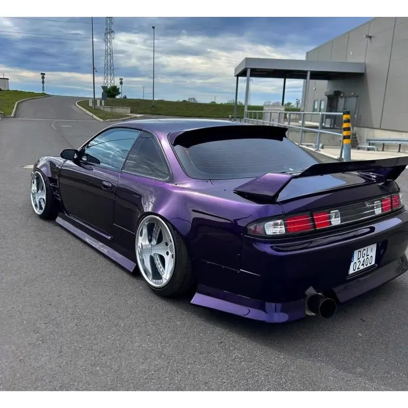 Rear-left view of a Nissan Silvia S14 wrapped in deep Midnight Purple Metallic - Kaleido