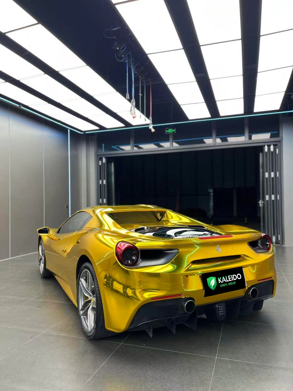 Ferrari 488 GTB in Mirror Chrome Gold vinyl - rear-left angle - Kaleido