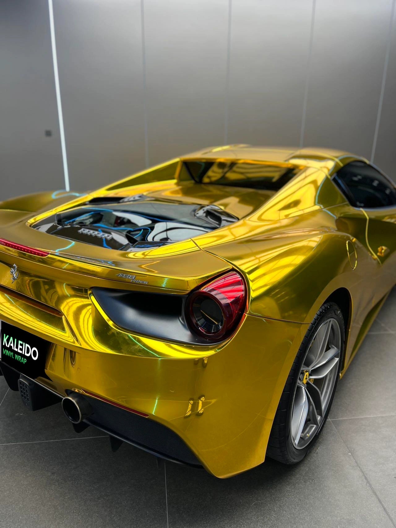 Rear-right view of a Mirror Chrome Gold wrapped Ferrari 488 GTB - Kaleido