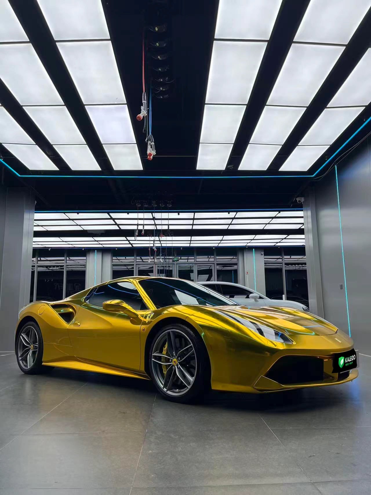 Side profile of a Ferrari 488 GTB with Mirror Chrome Gold vinyl - full reflective gold side - Kaleido