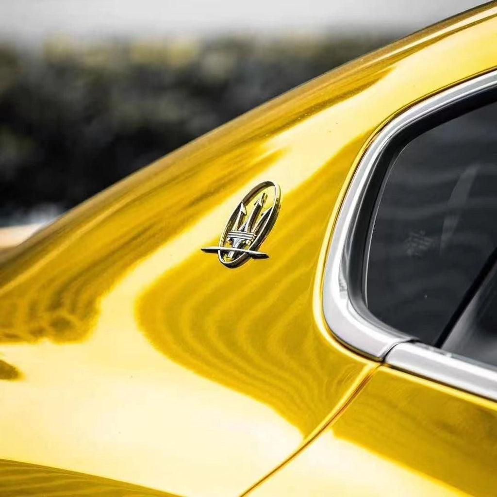 Close-up detail of Mirror Chrome Gold wrap on Maserati Quattroporte C-pillar - Kaleido