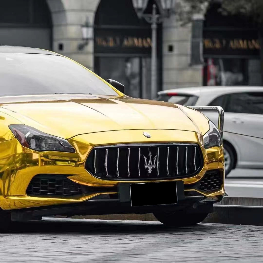 Detailed shot of Mirror Chrome Gold wrap on Maserati Quattroporte front bumper - Kaleido