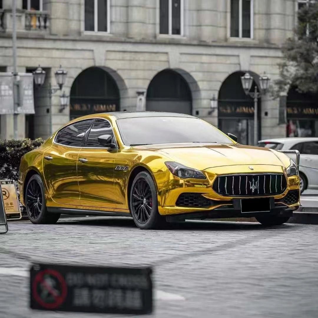 Wide front-right panoramic view of a Mirror Chrome Gold wrapped Maserati Quattroporte - Kaleido