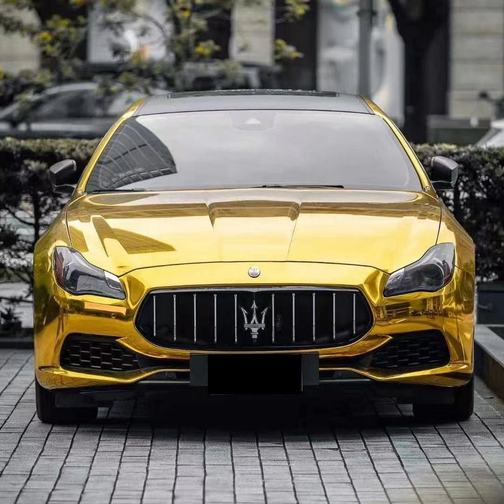 Front view of a Maserati Quattroporte luxury sedan in Mirror Chrome Gold wrap - Kaleido