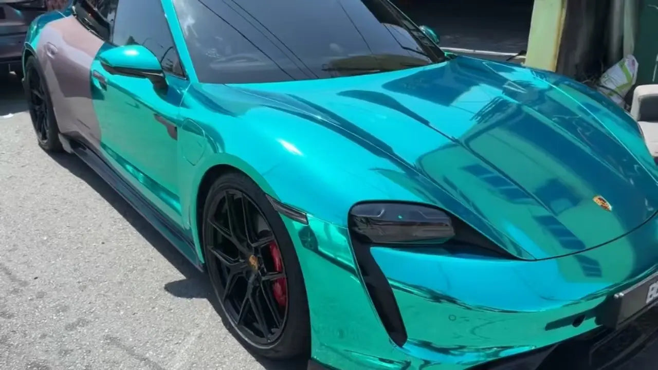 Porsche Taycan in Mirror Chrome Green - front-right hood view highlighting mirror-like reflection - Kaleido