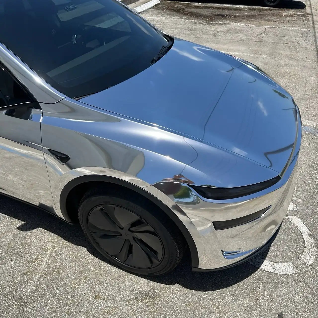 Close-up of Mirror Chrome Silver vinyl on Tesla Model Y hood - seamless mirror finish - Kaleido