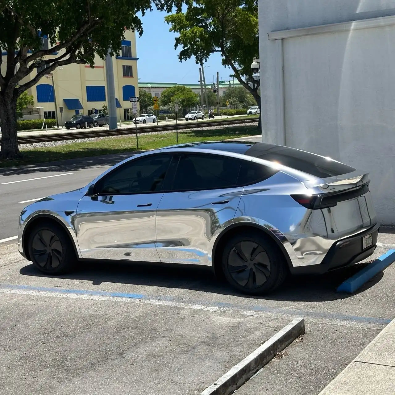 Full left side of Tesla Model Y in Mirror Chrome Silver wrap - smooth reflective surface - Kaleido