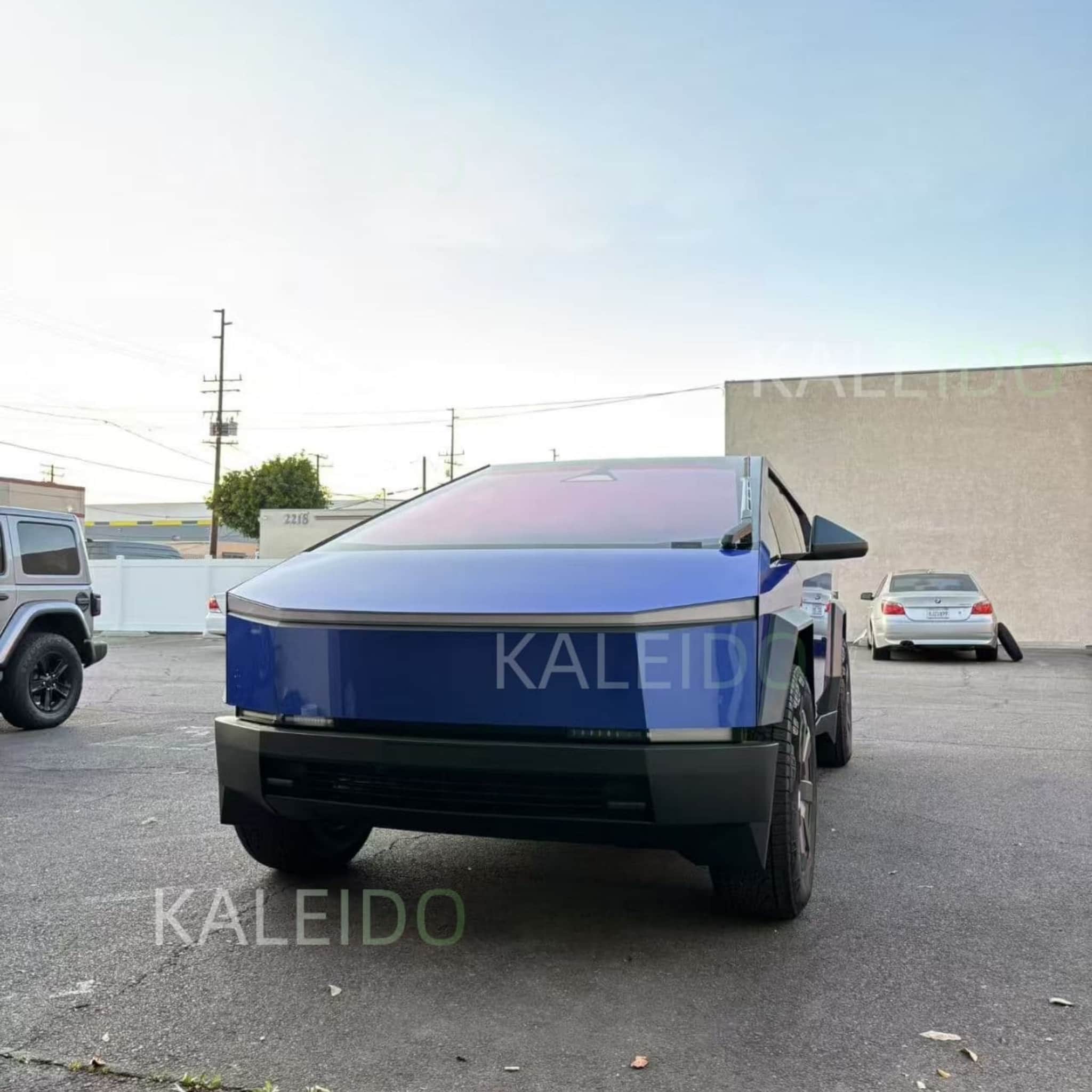Portimao Blue Metallic vinyl wrap on the front-left side of a Tesla Cybertruck - Kaleido