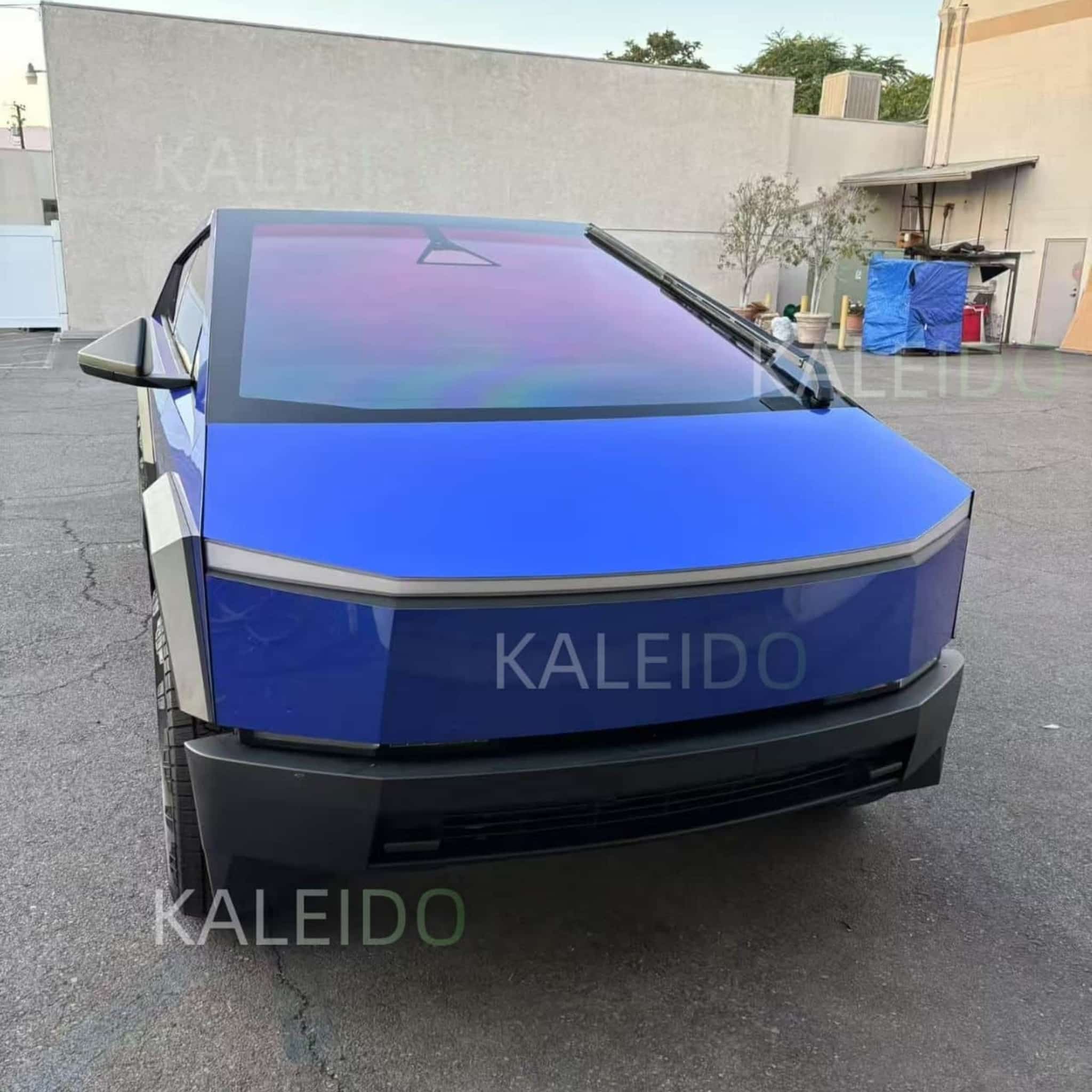 Front-right view of a Tesla Cybertruck wrapped in glossy Portimao Blue Metallic film - Kaleido