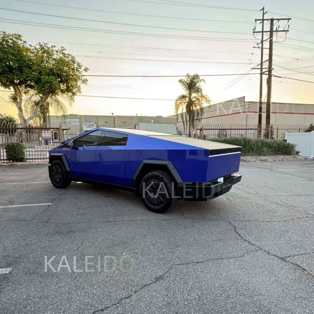 Portimao Blue Metallic wrap, rear-left angle of the angular Tesla Cybertruck - Kaleido