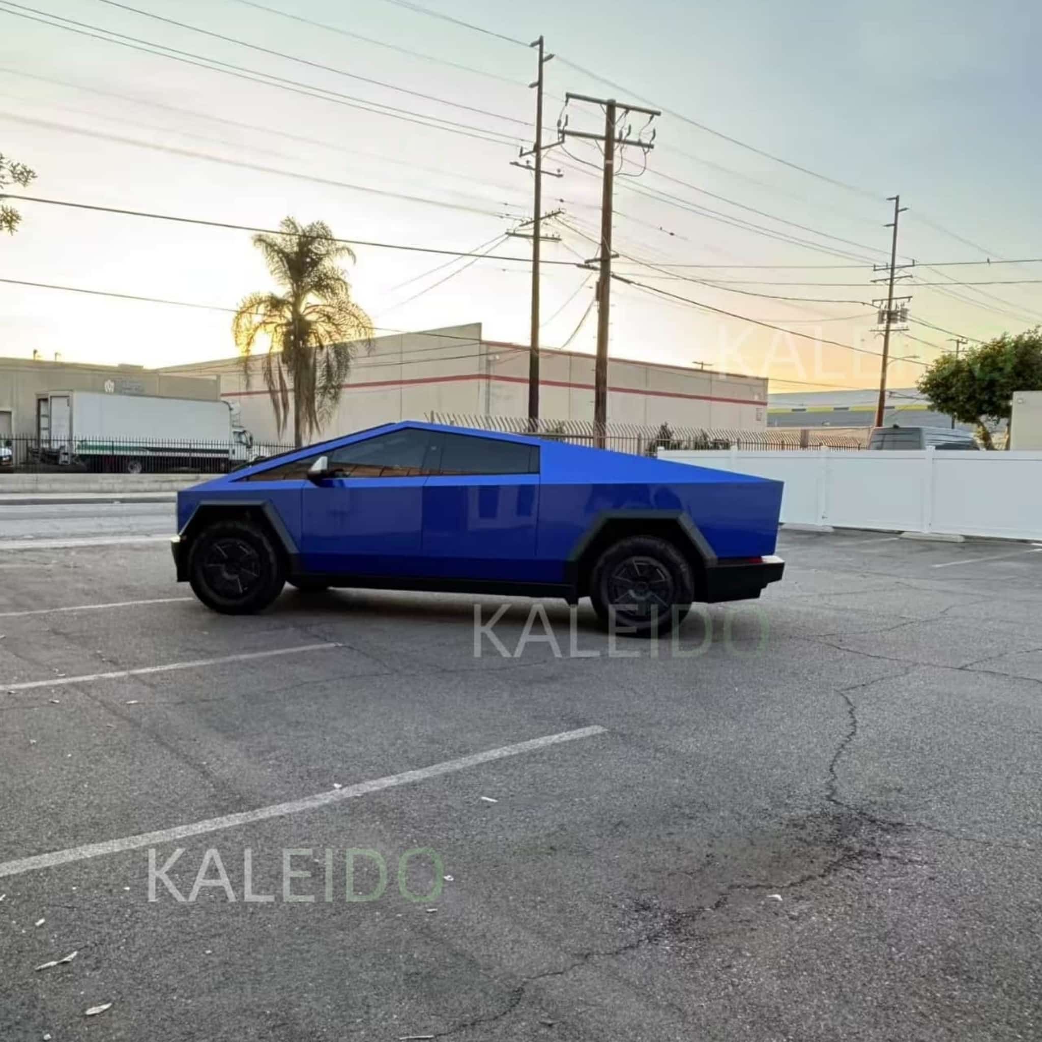 Clean side profile of the Tesla Cybertruck in Portimao Blue Metallic gloss vinyl - Kaleido