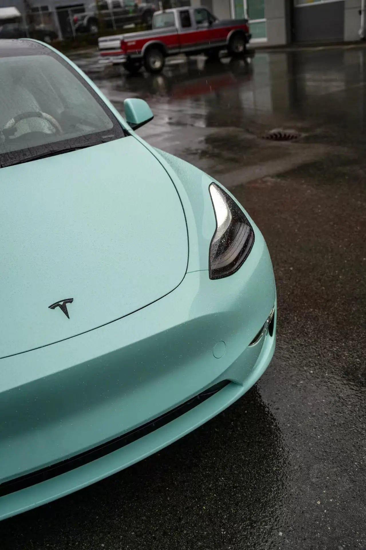Front bumper and hood area detail on a Rolls-Royce Sagano Green Tesla Model Y - Kaleido