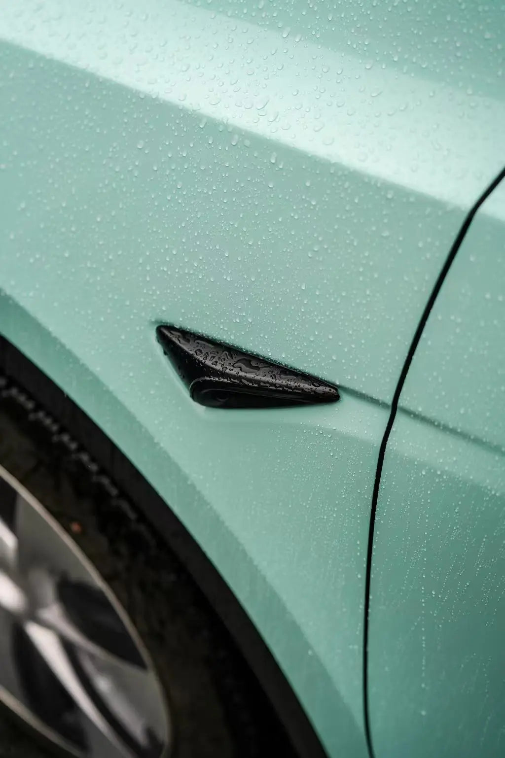 Close-up of the front fender on a Rolls-Royce Sagano Green wrapped Tesla Model Y - Kaleido