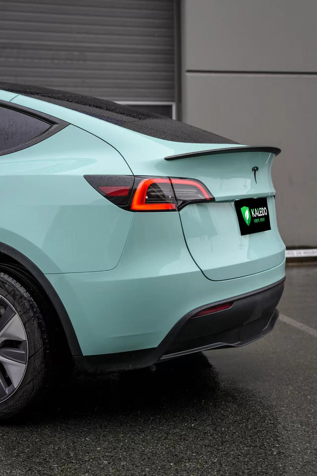 Left rear corner of a Tesla Model Y with Rolls-Royce Sagano Green vinyl - Kaleido