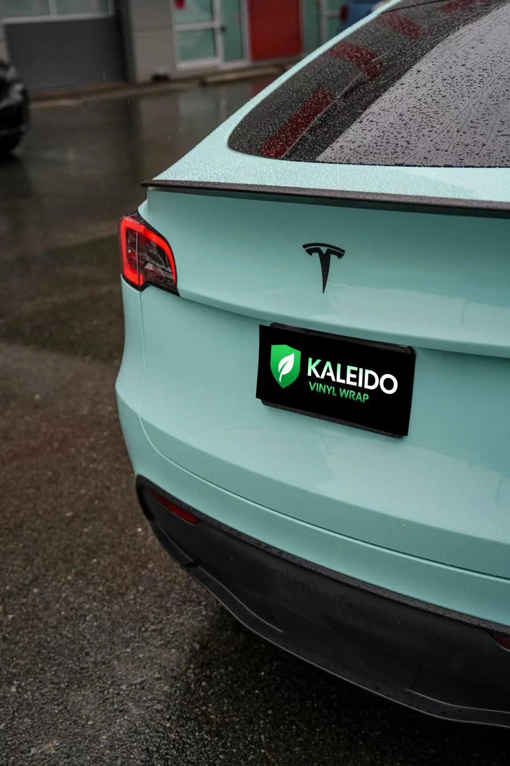 Detailed shot of Rolls-Royce Sagano Green on Tesla Model Y rear bumper - Kaleido