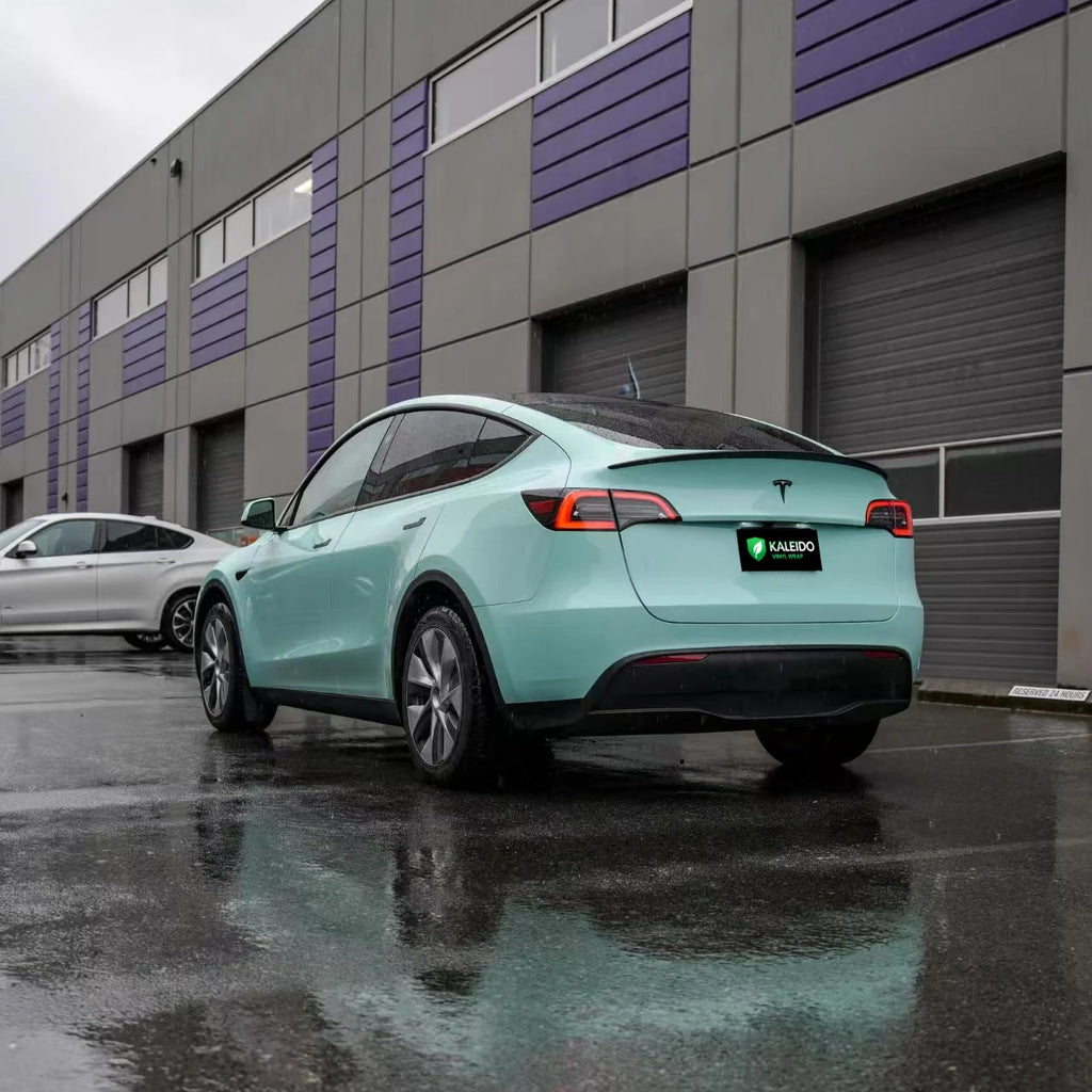 Rear-left angle of a Tesla Model Y in Rolls-Royce Sagano Green wrap - Kaleido