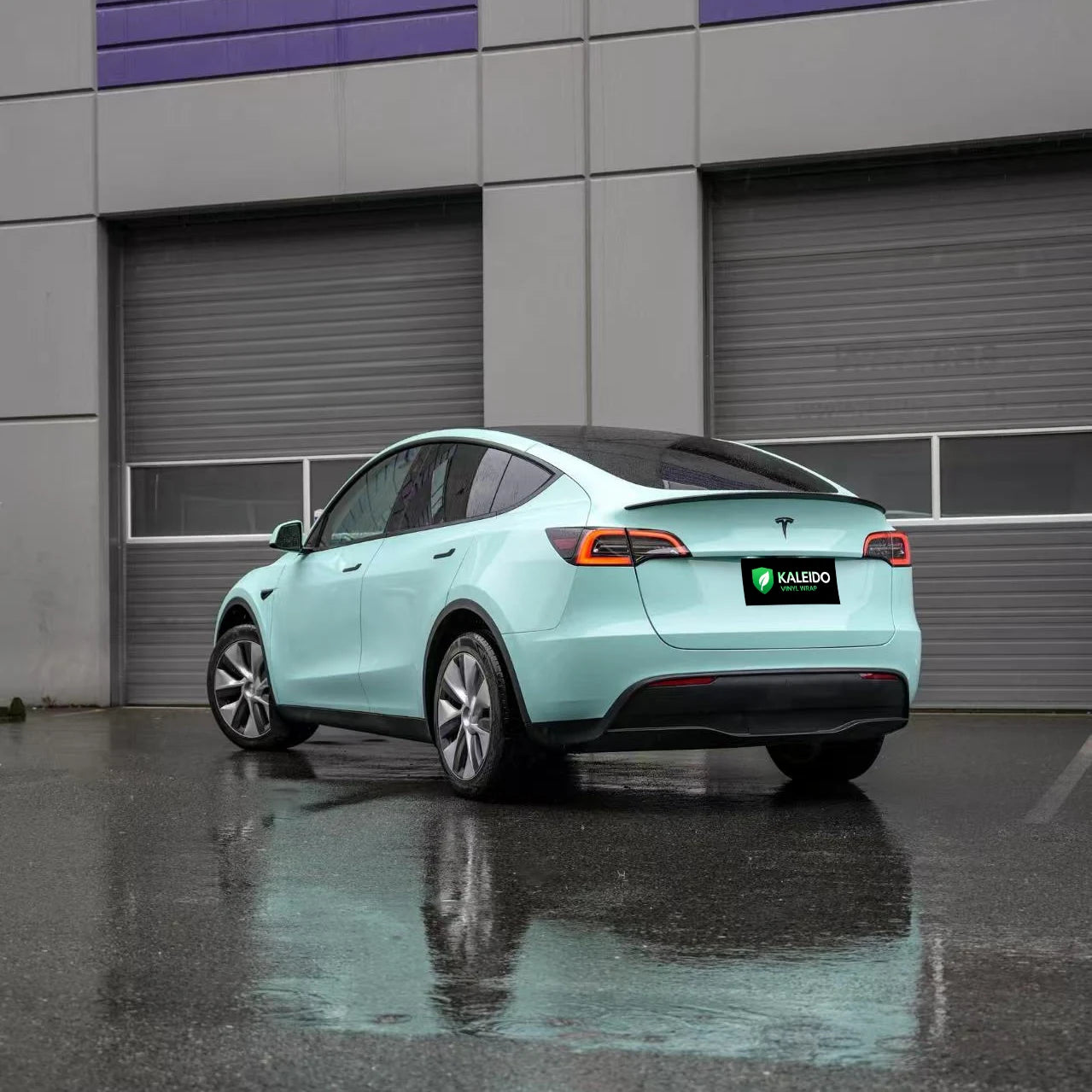 Rear-left view of a Rolls-Royce Sagano Green wrapped Tesla Model Y SUV - Kaleido