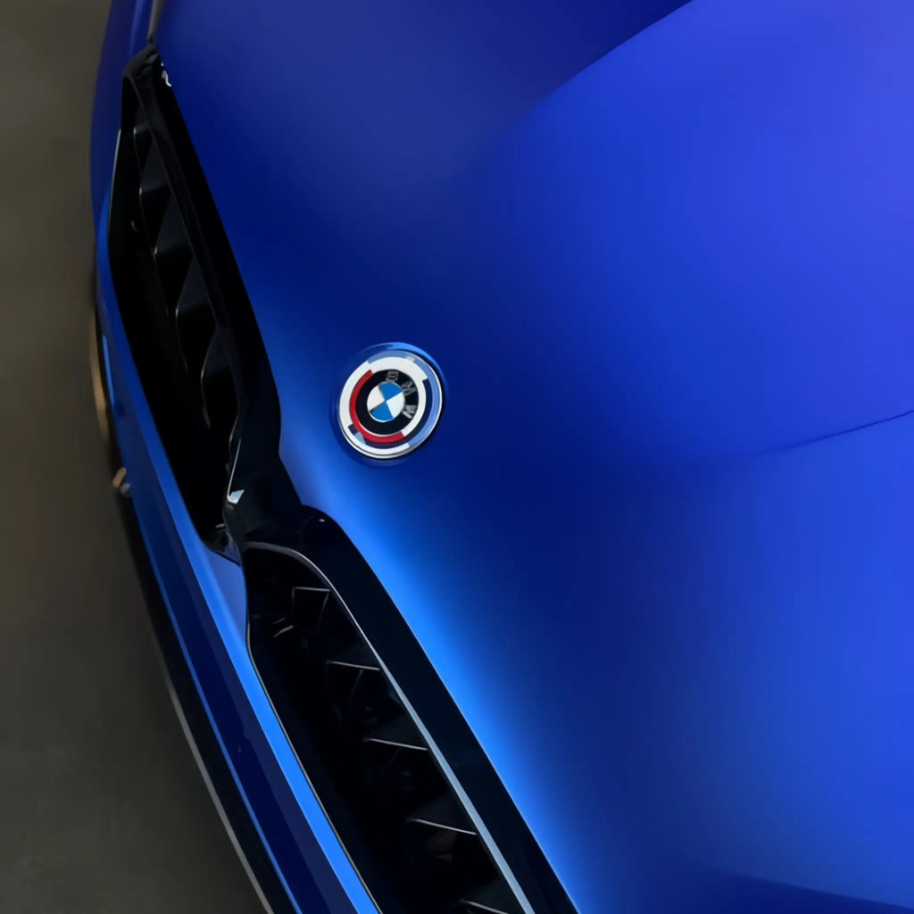 Close-up of Satin Chrome Abyss Blue film on BMW M5 front bumper - texture detail - Kaleido