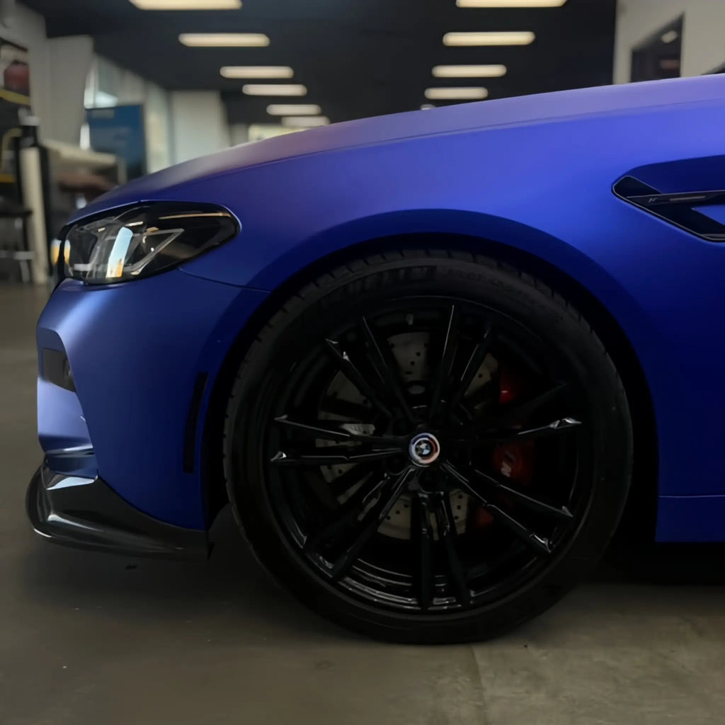 Satin Chrome Abyss Blue wrap on BMW M5 front-right corner - deep matte chrome blue finish on sports sedan - Kaleido