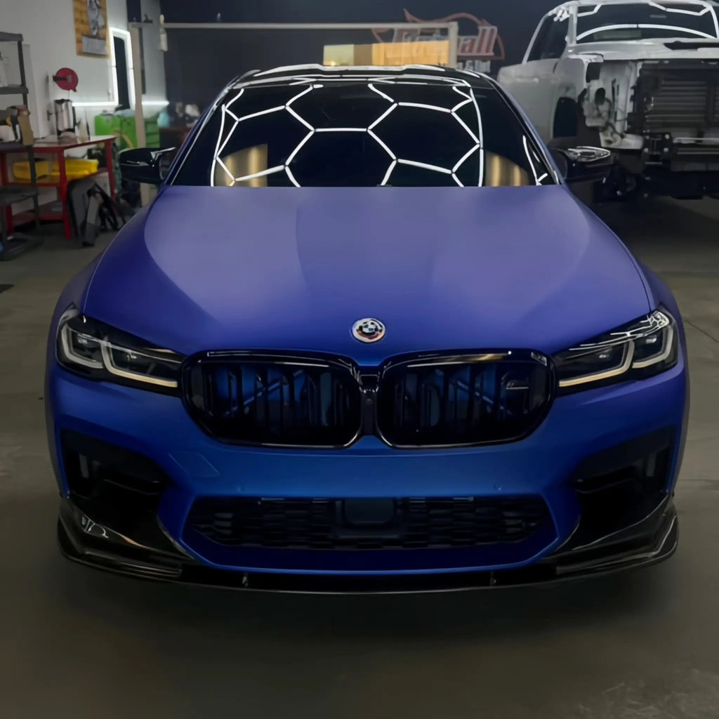 Front view of BMW M5 wrapped in Satin Chrome Abyss Blue - aggressive stance with deep blue finish - Kaleido