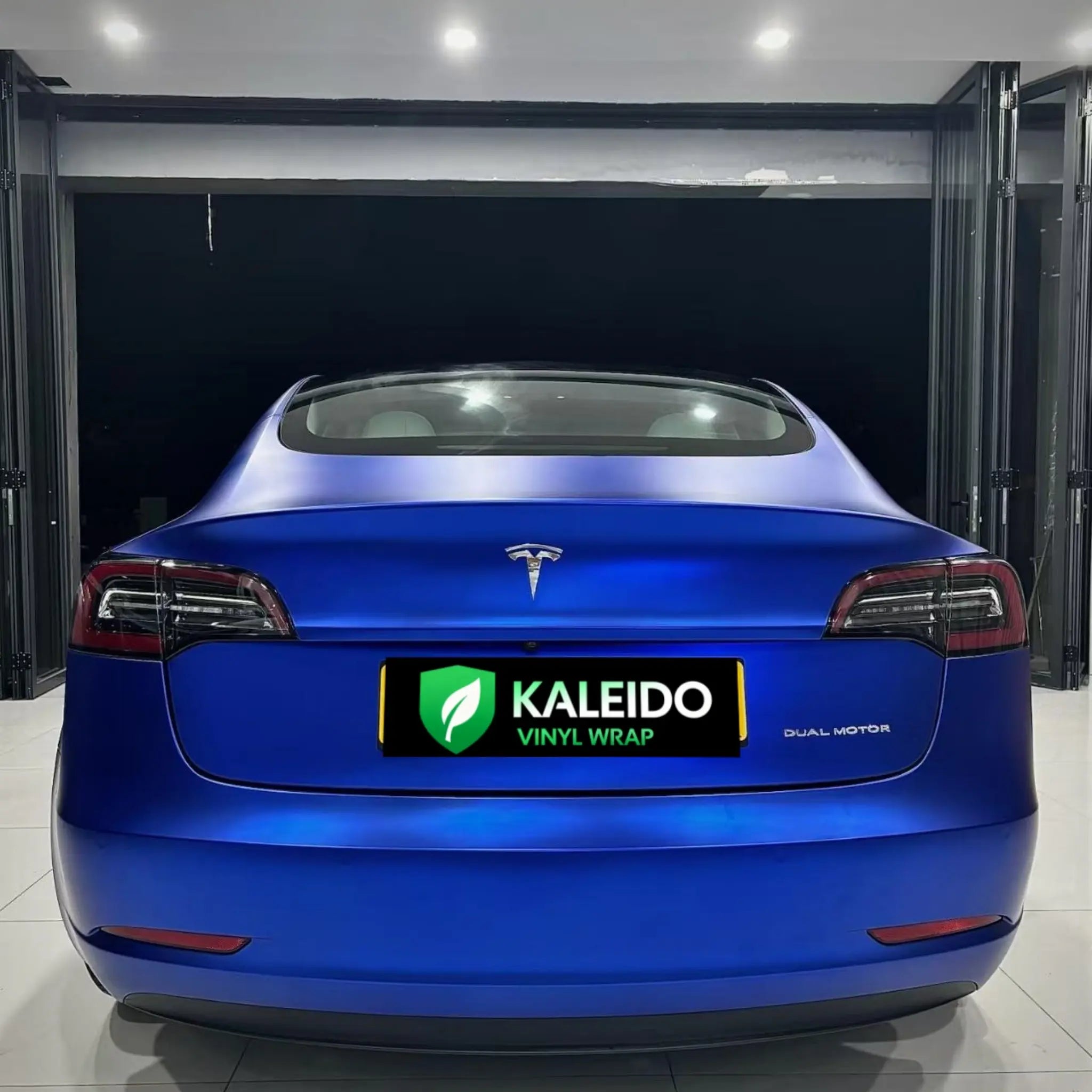 Tesla Model 3 in Satin Chrome Abyss Blue vinyl - rear view showing matte chrome finish - Kaleido