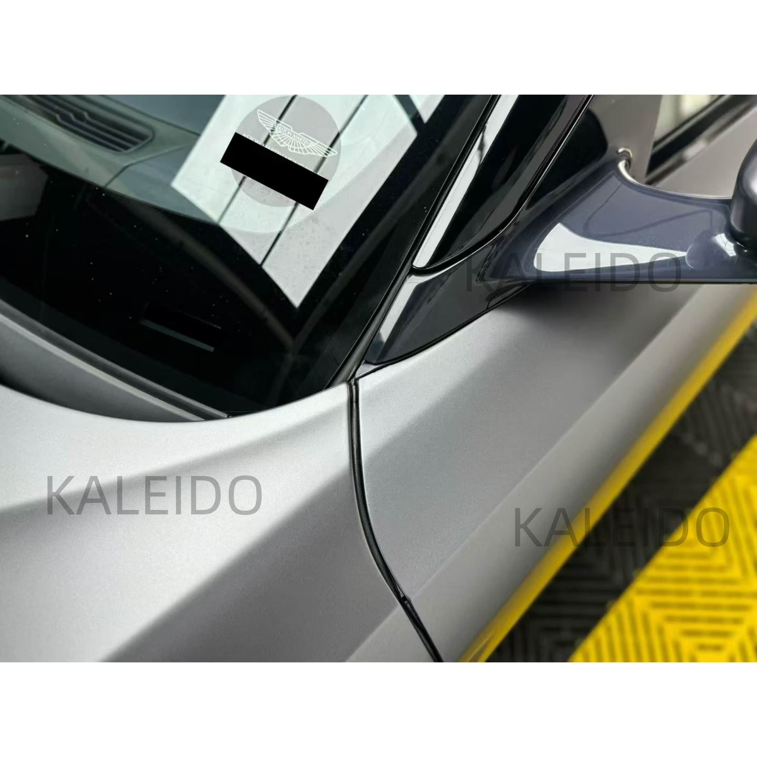 Close-up of the satin chrome wrap on the mirror caps of an Aston Martin DB11 - Kaleido