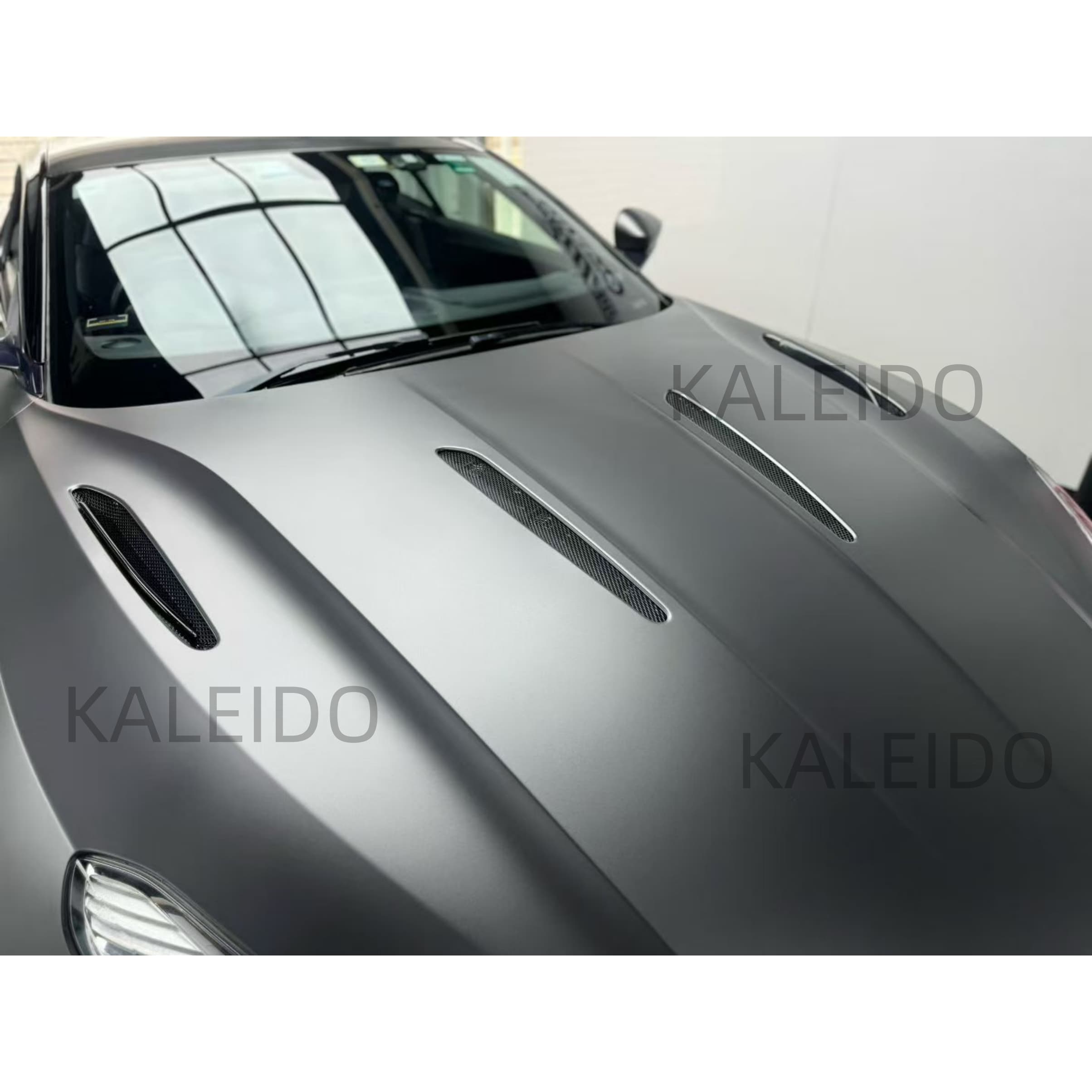 AMG Selenite Grey satin chrome vinyl flowing over the hood of the Aston Martin DB11 - Kaleido