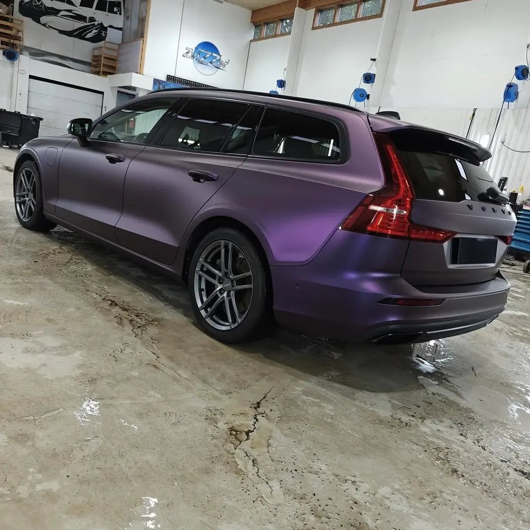 Satin Chrome Black Purple wrap on a Volvo V60 wagon - rear-left view showcasing the estate silhouette - Kaleido