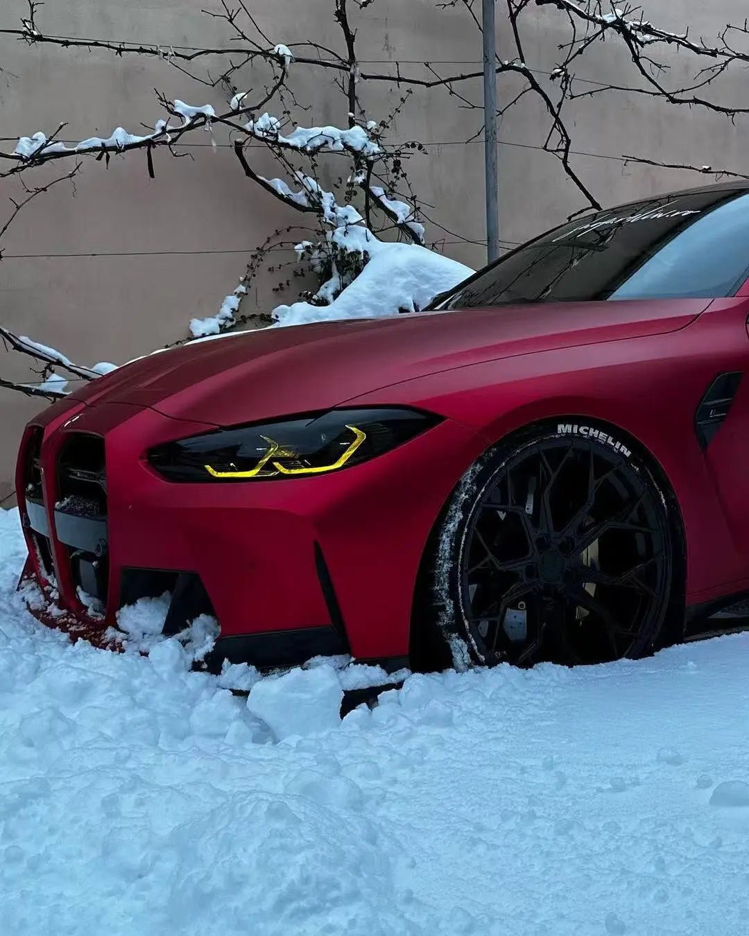 Detailed shot of Satin Chrome Romanee Red film on BMW M3 left front fender - Kaleido