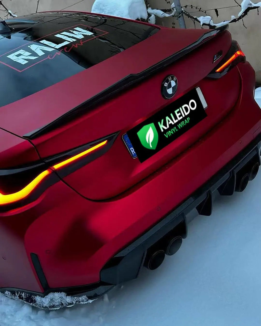 Close-up rear-left view of BMW M3 with Satin Chrome Romanee Red vinyl - Kaleido