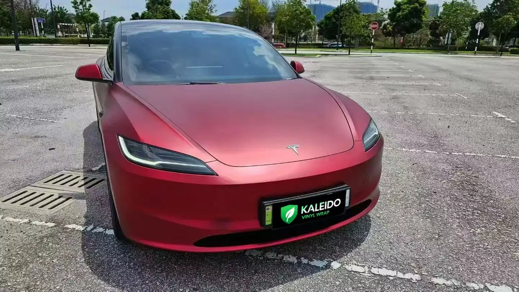 Satin Chrome Romanee Red vinyl wrap on Tesla Model 3 - front-right angle showcasing deep burgundy matte metallic finish - Kaleido