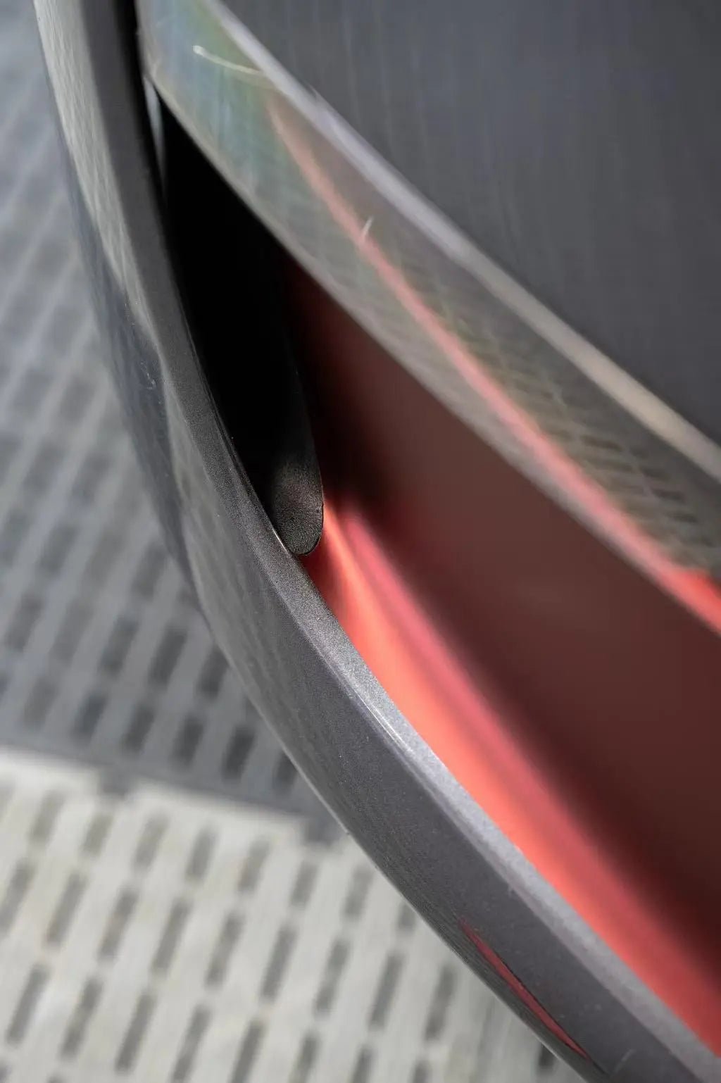 Detailed shot of Satin Chrome Silk Red wrap on Tesla Model Y front bumper - Kaleido