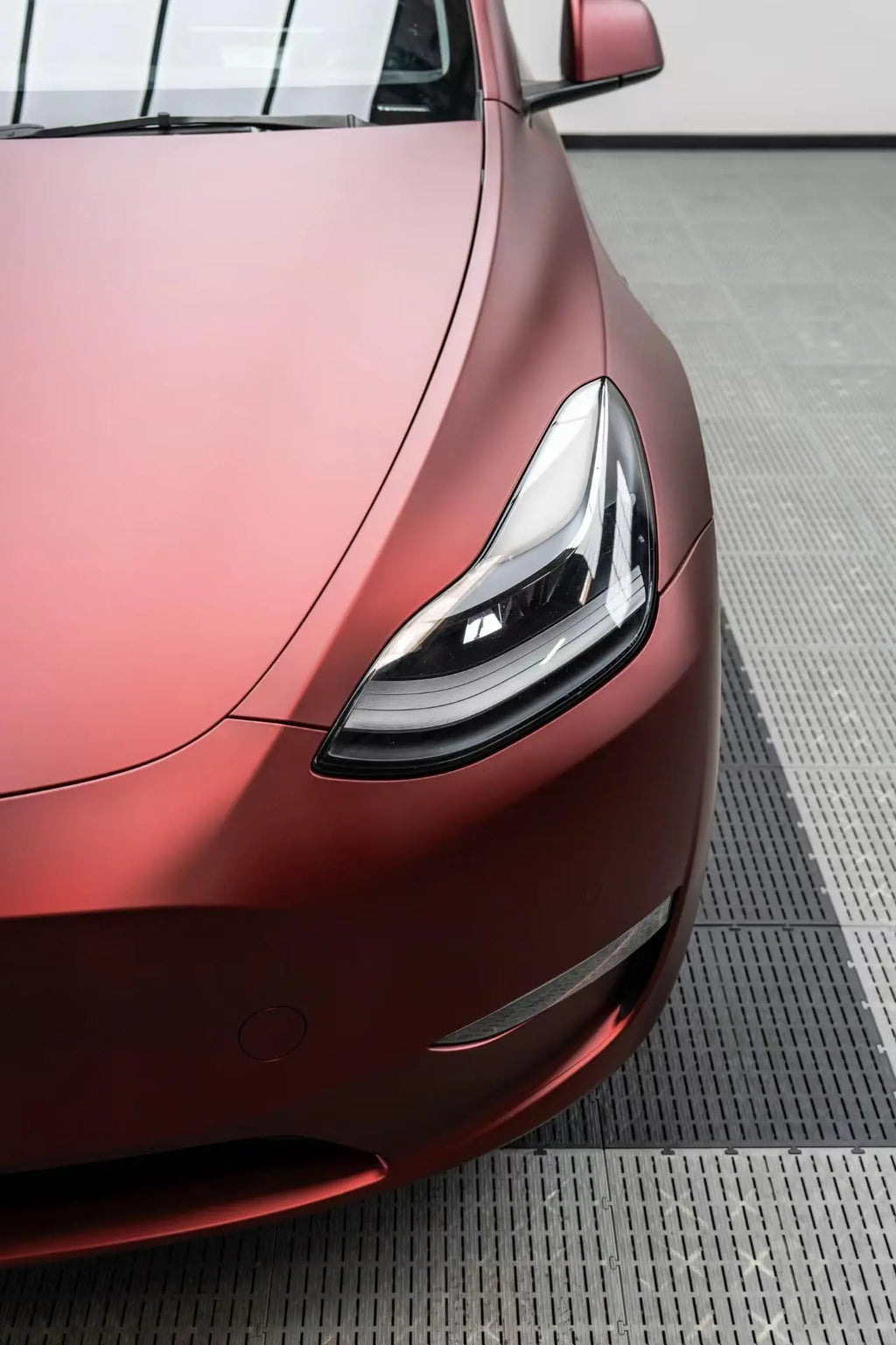 Front-left corner of Tesla Model Y with Satin Chrome Silk Red wrap - rich red matte metallic - Kaleido