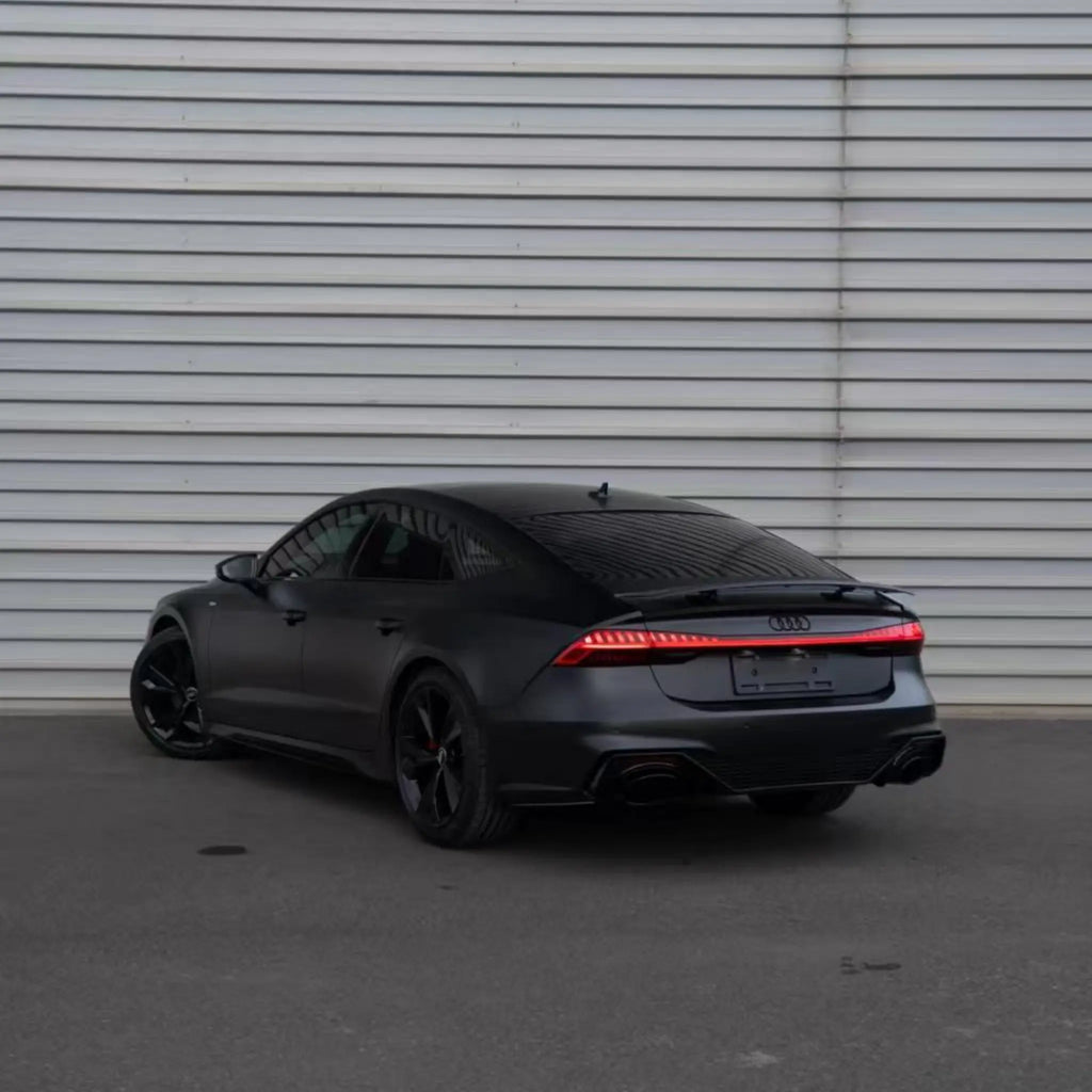 Wide rear-left view of a Satin Chrome Vantablack wrapped Audi RS7 Sportback (C8) - Kaleido