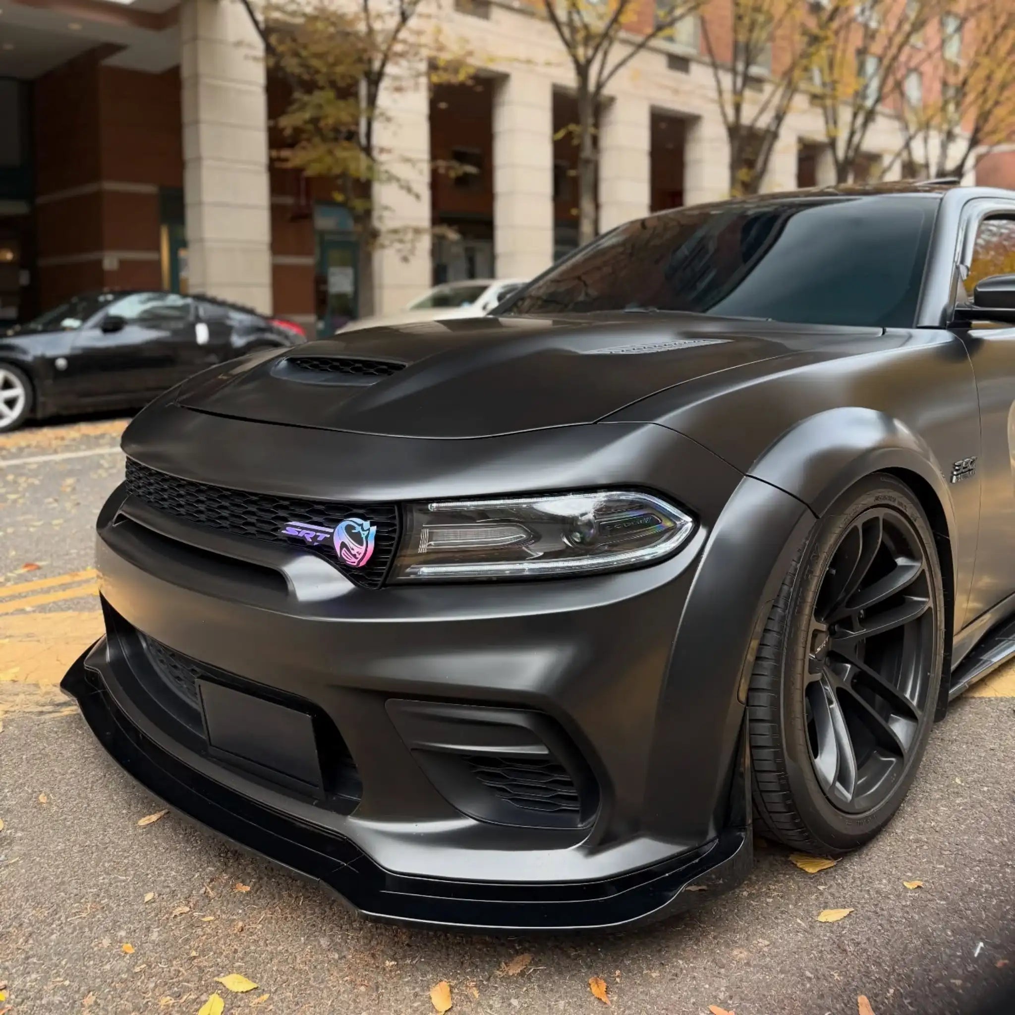 Close-up front-left detail of Satin Chrome Vantablack film on a widebody Dodge Charger SRT - Kaleido