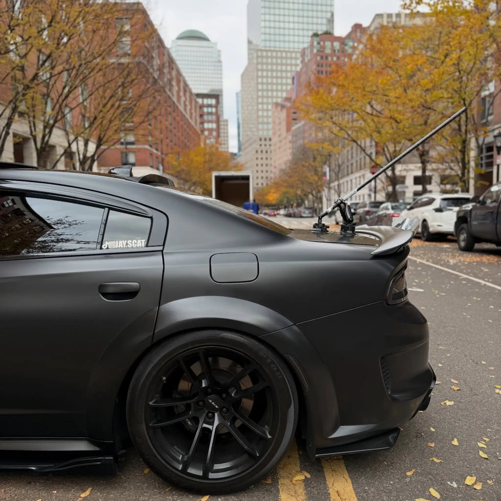 Rear-left corner detail of a widebody Charger SRT wrapped in Satin Chrome Vantablack - Kaleido