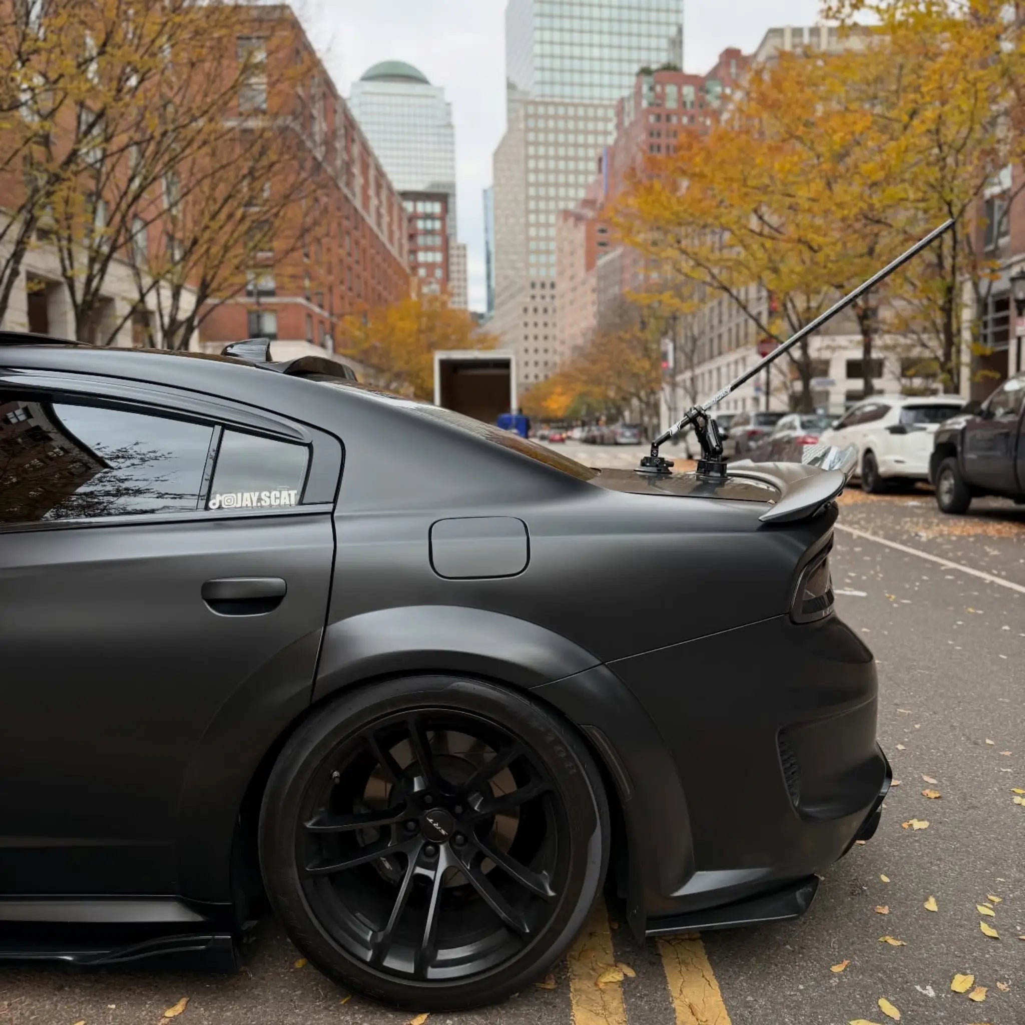 Rear-left corner detail of a widebody Charger SRT wrapped in Satin Chrome Vantablack - Kaleido