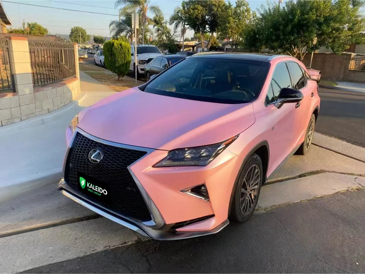 Overhead front-left view of a Satin Metallic Sakura Pink wrapped Lexus RX SUV - Kaleido