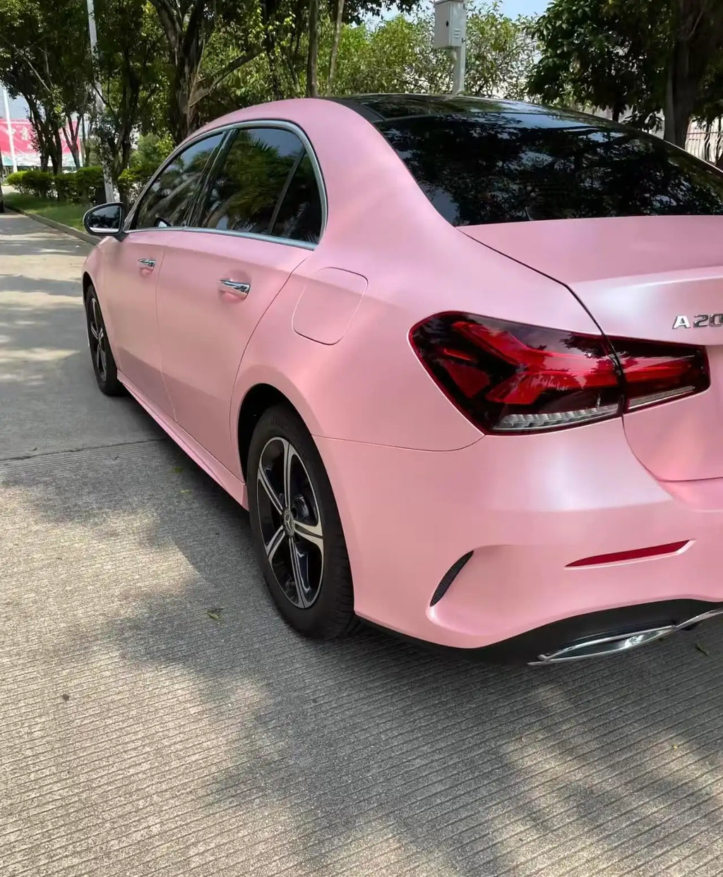 Rear-left angle of a Mercedes A-Class with Satin Metallic Sakura Pink vinyl wrap - Kaleido