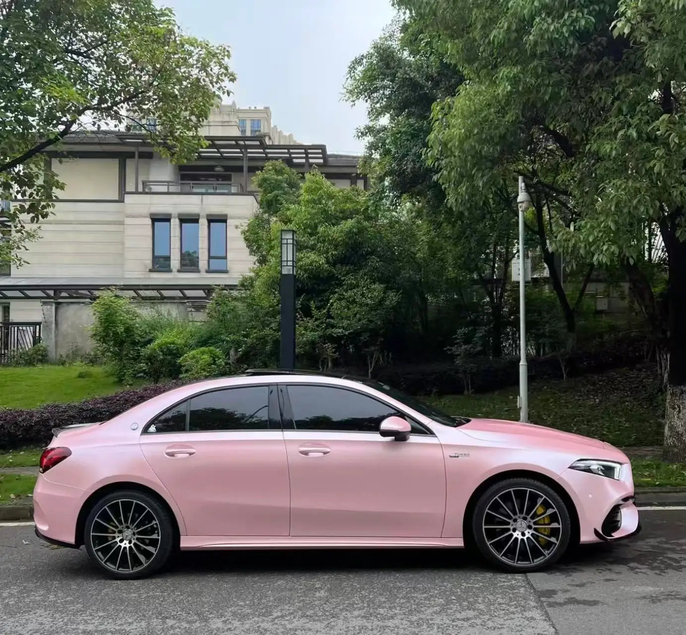 Right side view of a Satin Metallic Sakura Pink wrapped Mercedes A-Class compact sedan - Kaleido