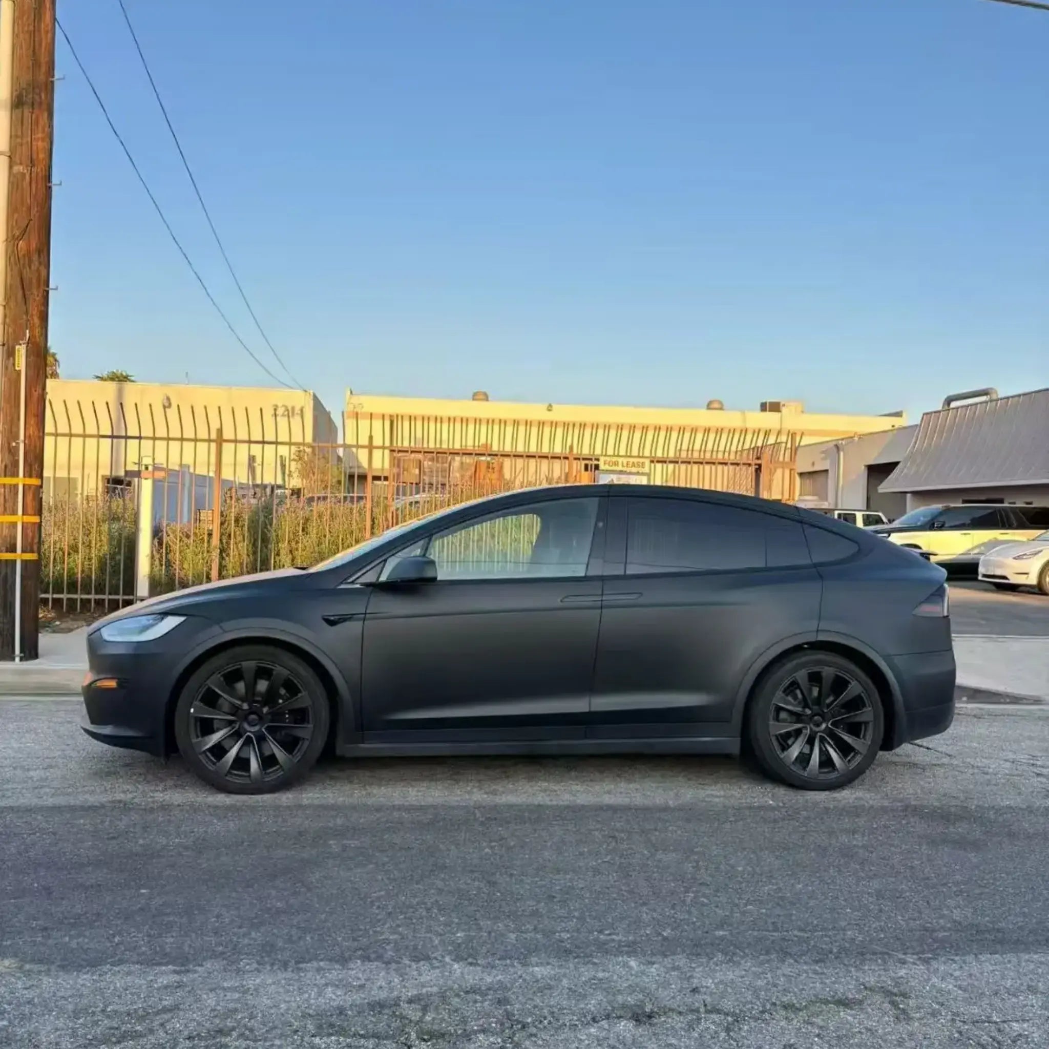 Left side profile of Tesla Model X wrapped in Stealth Matte Black - showcasing SUV silhouette - Kaleido