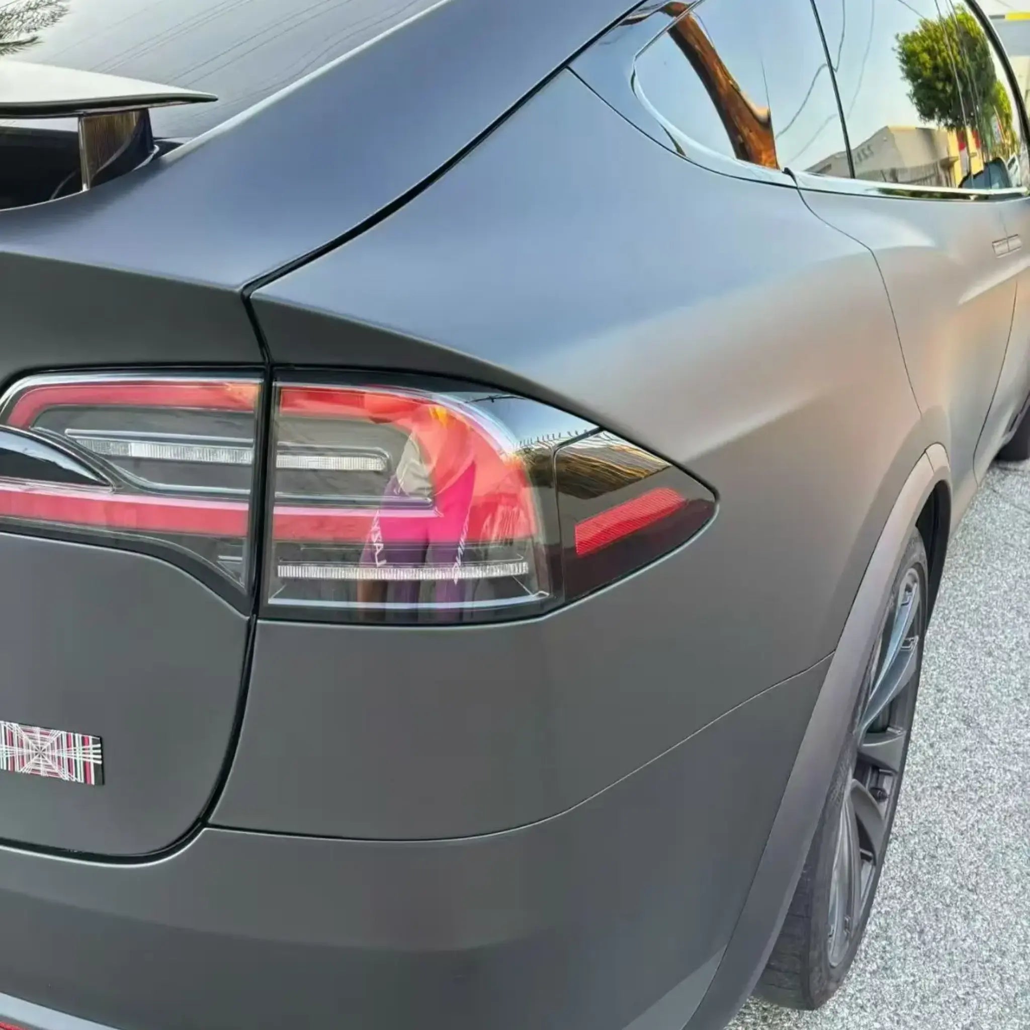 Detailed shot of Stealth Matte Black vinyl on Tesla Model X right rear corner - Kaleido