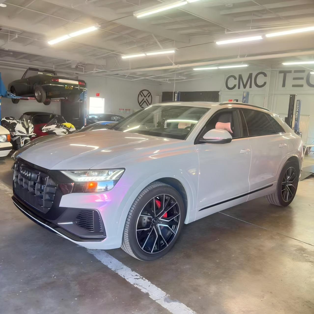 Audi Q8 in Volcanic Aura color shift vinyl - front-left view showing grey to pink finish - Kaleido