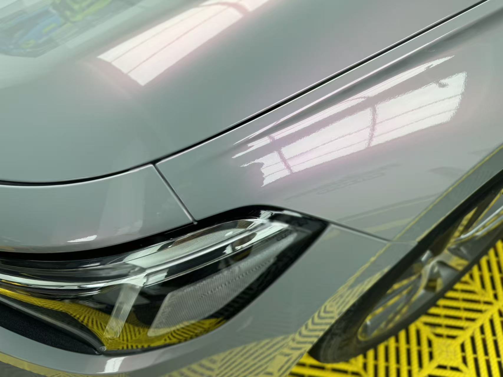 Close-up detail of Volcanic Aura film on Honda Civic front-left - color shift texture - Kaleido